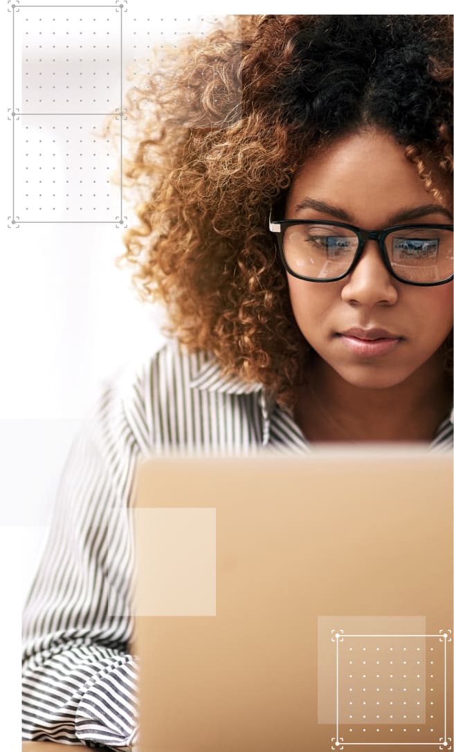 A young professional at work looking at her laptop screen